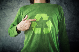 Man pointing to RECYCLE symbol printed on his shirt environment preservation activist.